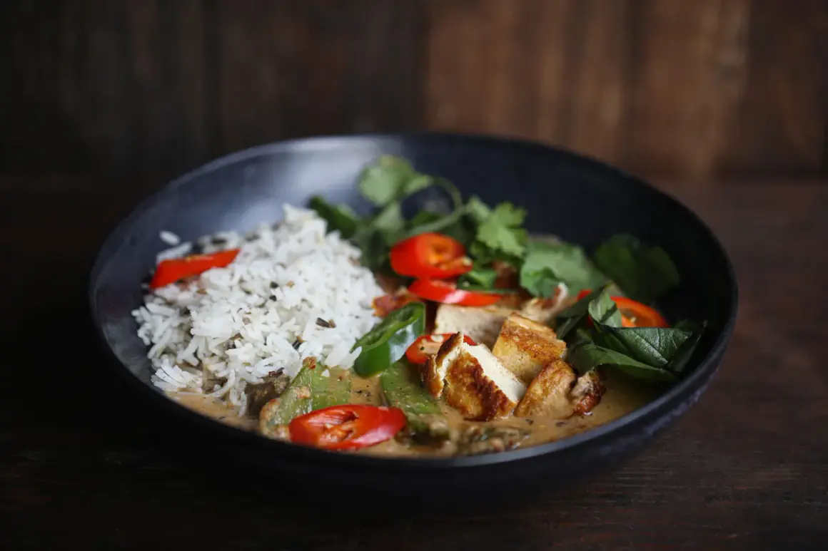 Schüssel mit Reis, Tofu, Erbsen, Chili und Koriander. Ein authentisches Thai Curry Rezept original.
