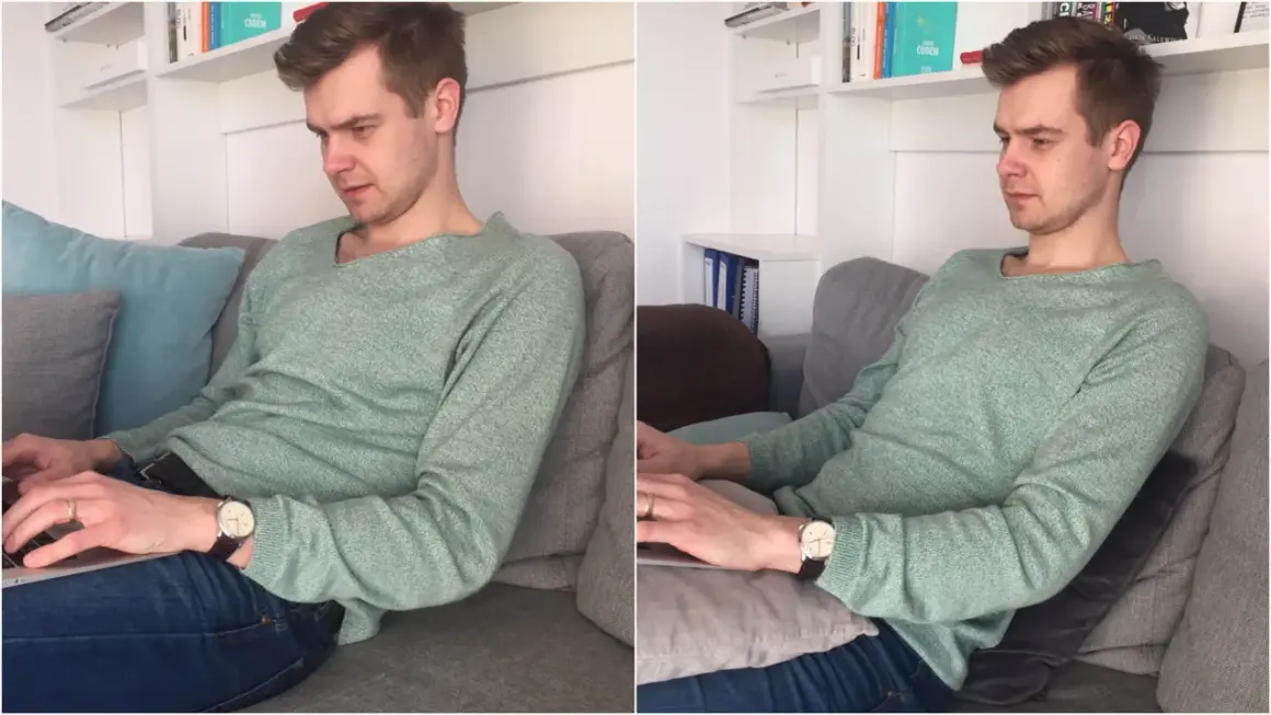 Mężczyzna w swetrze siedzi w **pozycji półleżącej** na kanapie, pracując na laptopie.