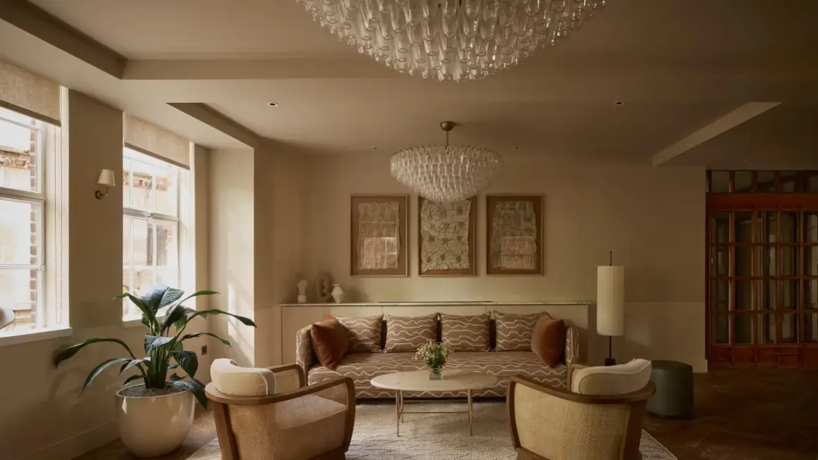 Ein Wohnzimmer im **lagom Lebensstil**: Gemütliche Sitzmöbel, dezente Farben, natürliche Materialien und Kunstwerke schaffen eine harmonische Atmosphäre.