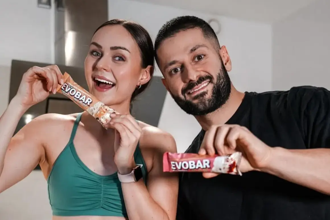 Ein glückliches Paar hält proteinriegel vor dem sport. Sie sind bereit für ihr Training mit EVOBAR.