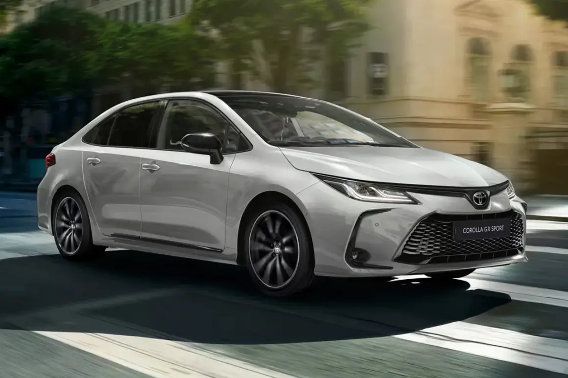 Srebrna Toyota Corolla Hybrid GR Sport 2022 w ruchu miejskim. Sprawdź atrakcyjną toyota corolla hybrid 2022 cena.