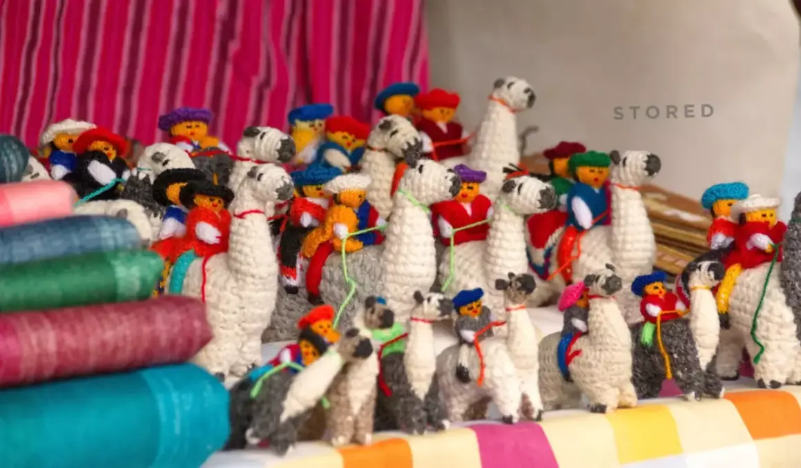 A collection of charming, handmade llama stuffed animals, showcasing creative stuffed animal storage ideas.