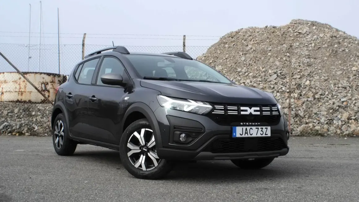 En mörkgrå Dacia Sandero Stepway står parkerad utomhus. Bilen är redo för ett däcktest.
