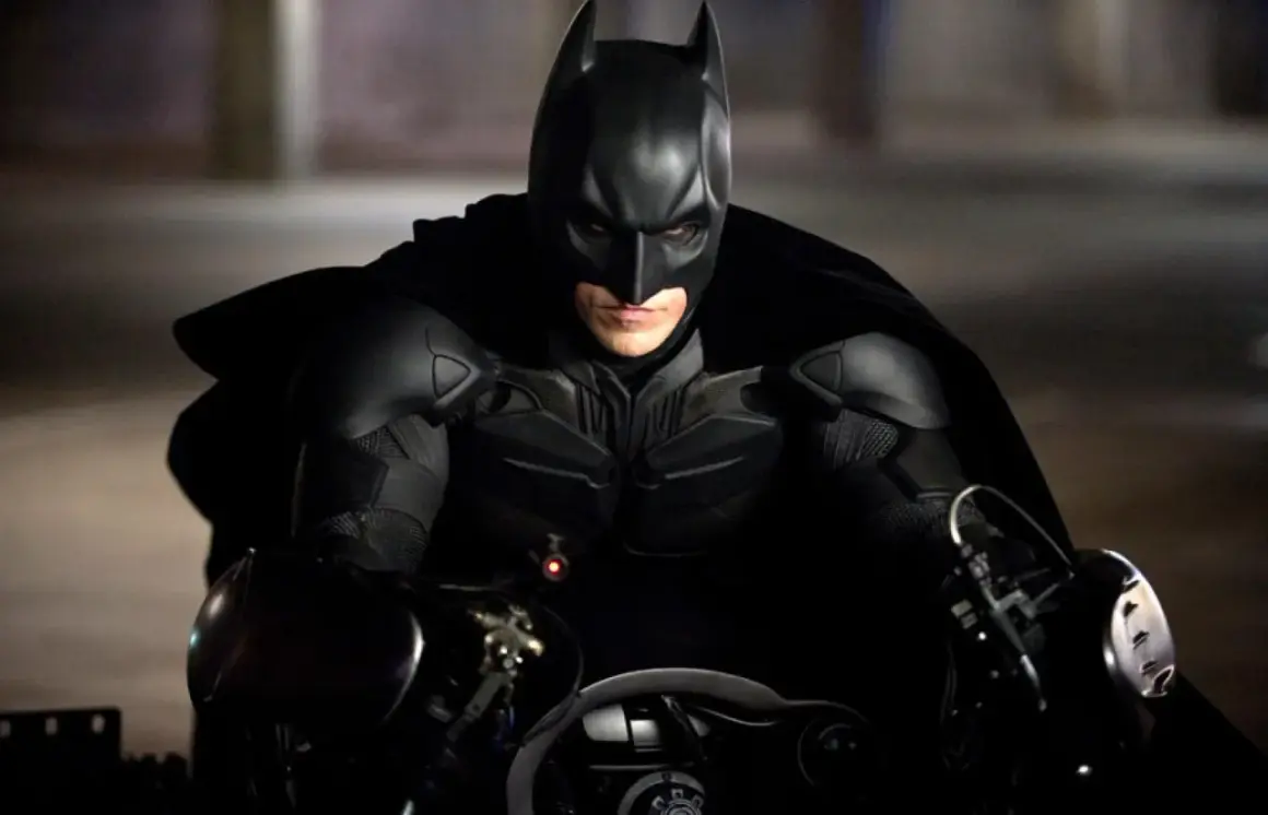 Mroczny rycerz, Nolan Batman, w swoim pancerzu i pelerynie, gotowy do akcji na Batpodzie.