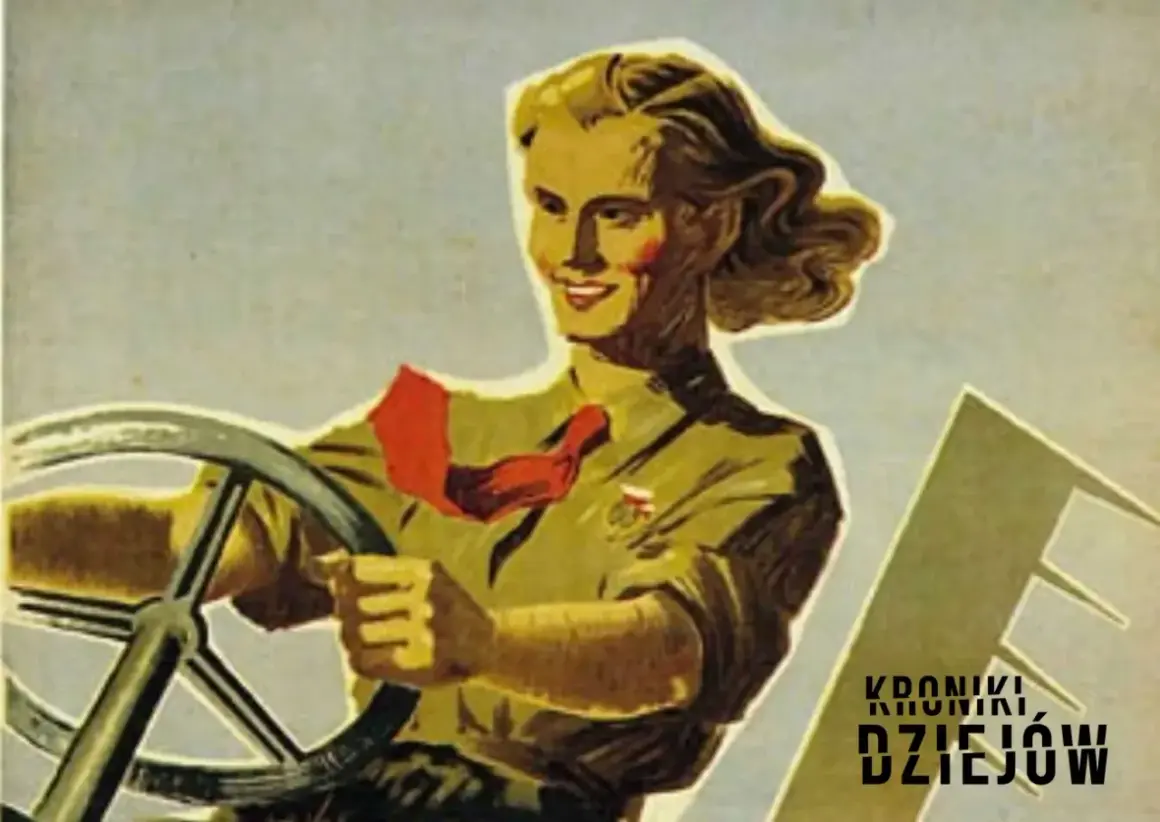 Kobieta za kierownicą, w stylu radzieckich plakatów propagandowych. Uśmiechnięta, z czerwoną chustą na szyi, symbolizuje postęp i siłę.