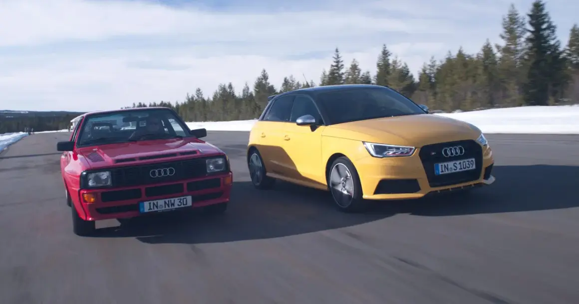 Dwa Audi S1 Quattro, czerwony klasyk i żółty współczesny, pędzą po drodze wśród zimowych krajobrazów.