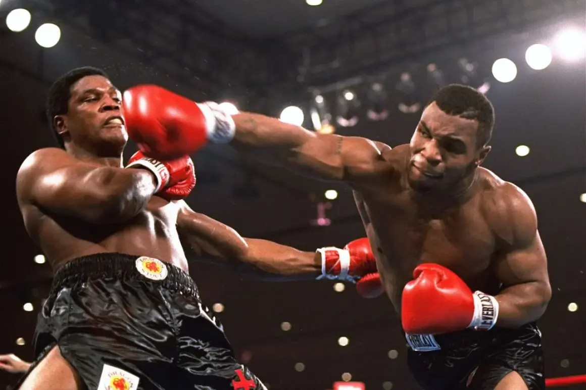 Mike Tyson prime lands a powerful punch in a boxing match, his opponent recoiling from the impact.