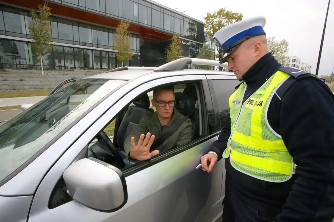 Policjant rozmawia z kierowcą, który może otrzymać zatrzymanie prawa jazdy na 3 miesiące.