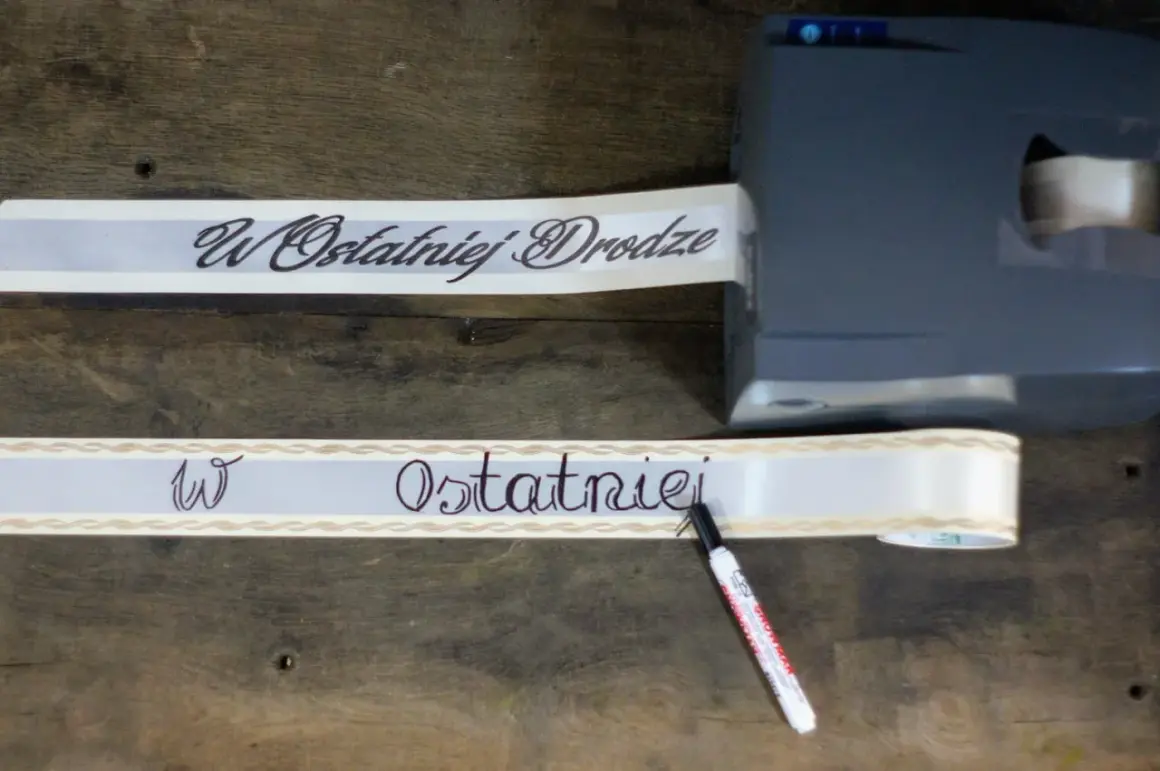 Szarfa pogrzebowa z napisem "W Ostatniej Drodze" jest drukowana i pisana ręcznie.