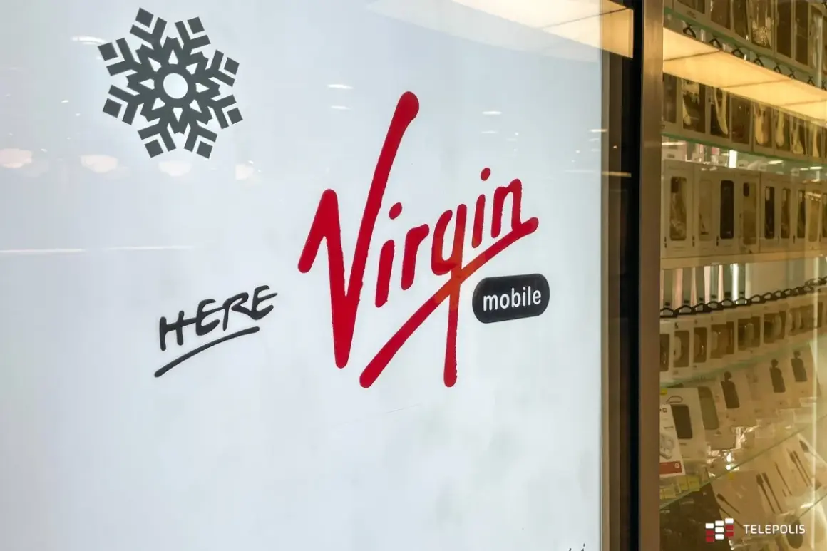 Logo Virgin Mobile, z napisem "HERE". Właściciel sieci Virgin Mobile zaprasza do swojego sklepu.