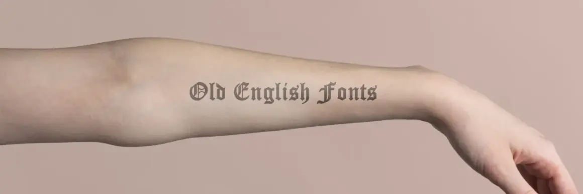 Ein Arm mit einem Tattoo-Schriftzug in Old English Fonts.