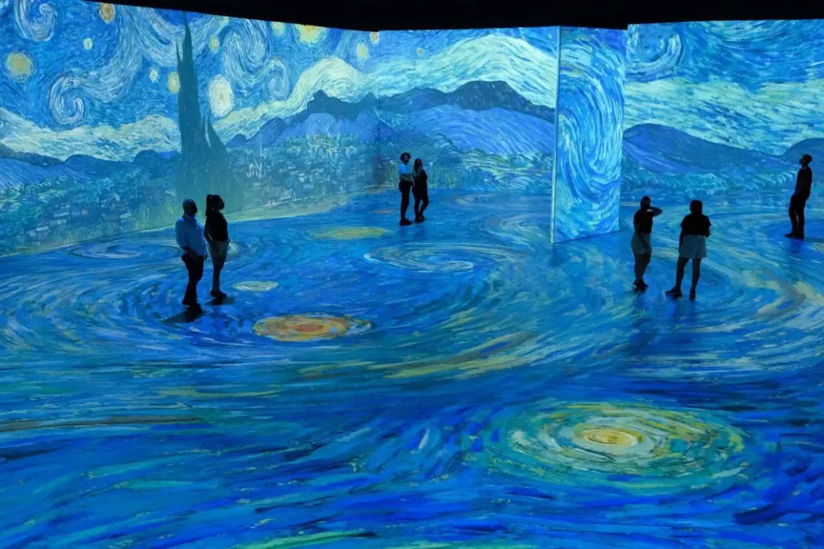 Visitors stand immersed in a swirling, starry landscape, a breathtaking projection of a Van Gogh painting.
