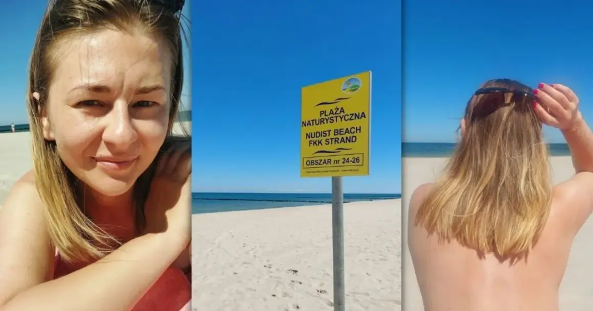 Uśmiechnięta kobieta na plaży nudystów. Obok tablica informująca o obszarze.