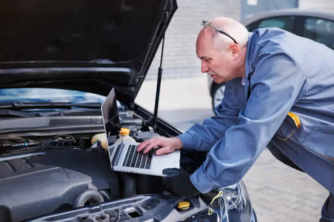 Mechanik diagnozuje awarię pojazdu Opel Astra J za pomocą laptopa. Skontaktuj się z serwisem Opel Astra J w razie problemów.