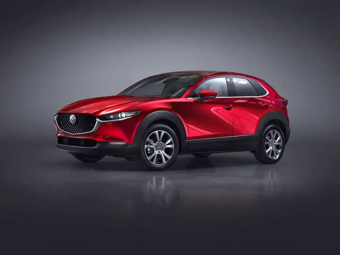 Röd Mazda CX-30 hybrid i studio. En elegant SUV redo för en provkörning.
