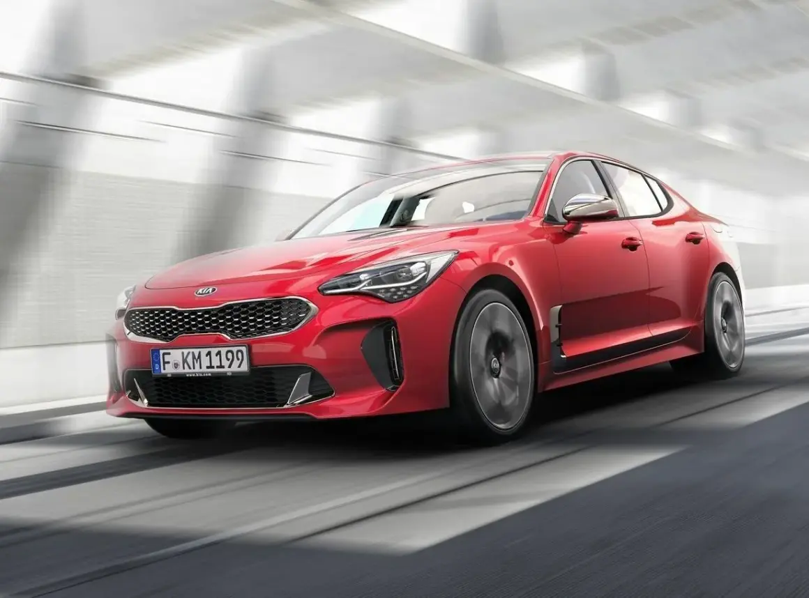 Czerwony Kia Stinger pędzi przez tunel. Sprawdź atrakcyjną kia stinger cena!