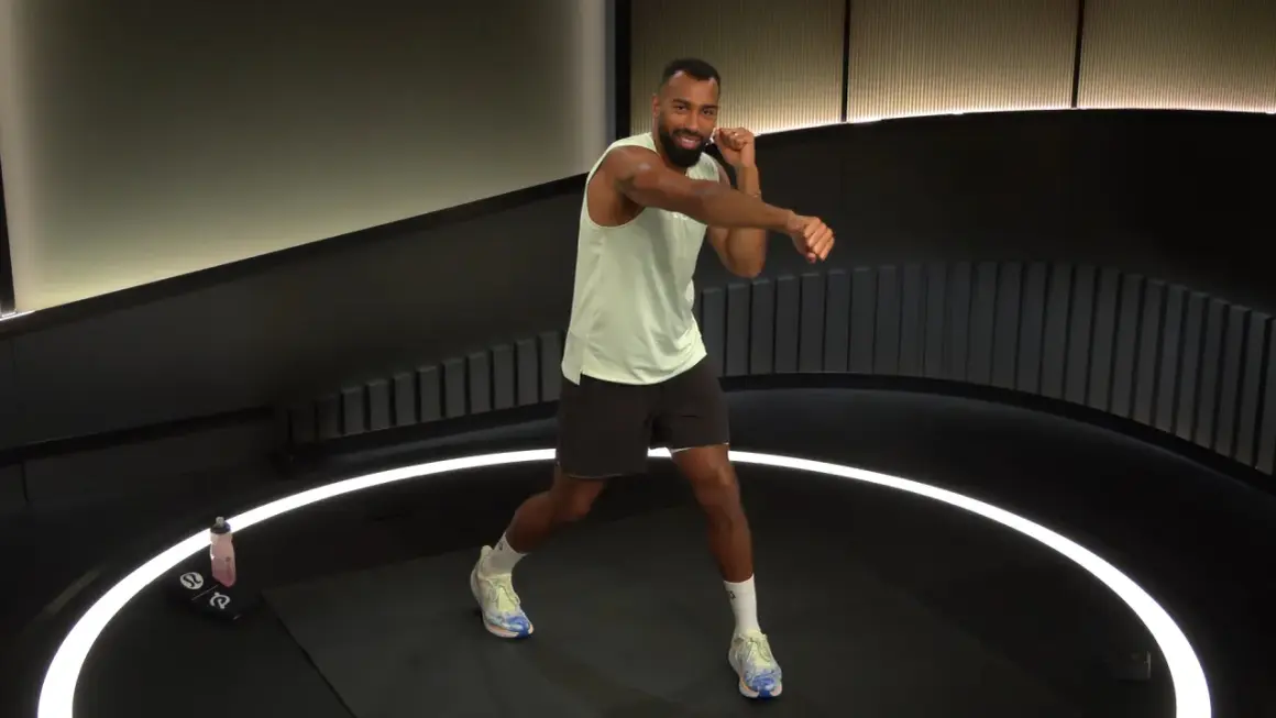 Man in athletic wear throws a powerful cross punch during a workout.