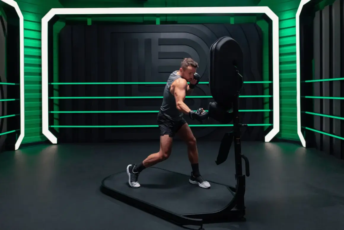 A man in boxing gloves practices his jab and cross, demonstrating proper boxing terminology in a futuristic ring with neon green accents.