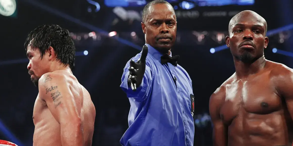 Referee signals between boxers, hinting at a close fight that could end in a majority decision vs split decision.