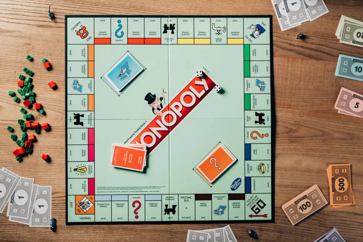 Plansza do gry Monopoly, pionki, domki i pieniądze. Kto pierwszy zdobędzie dublet w Monopoly?
