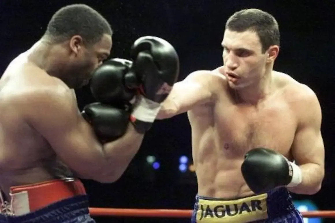 Vitali Klitschko boxing match, throwing a punch. His opponent is defending.