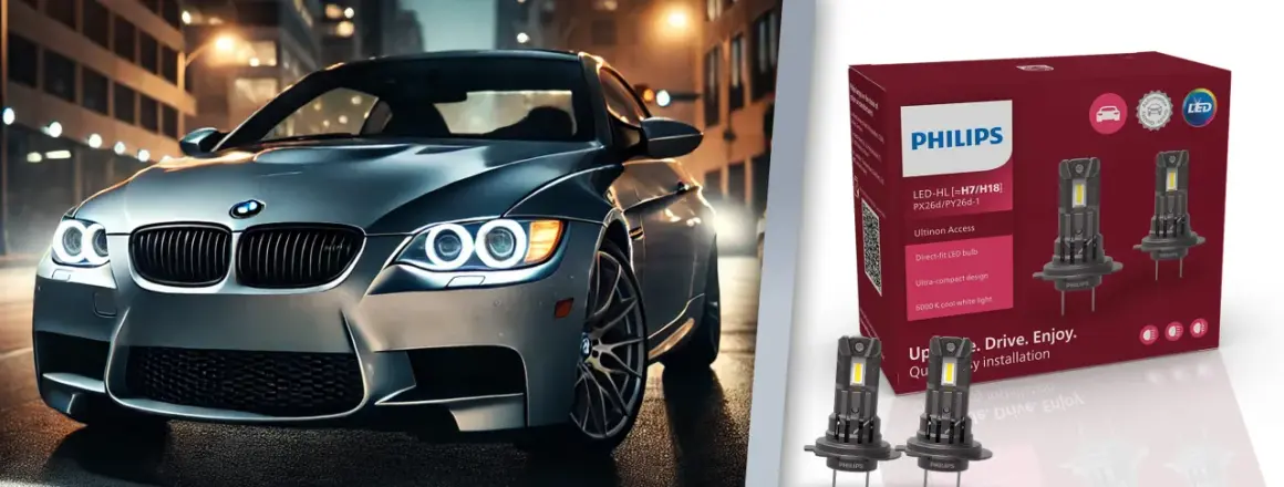 Srebrne auto z włączonymi światłami LED na tle miasta. Obok opakowanie żarówek Philips Ultinon Access, które jakie żarówki odmienią nocną jazdę.