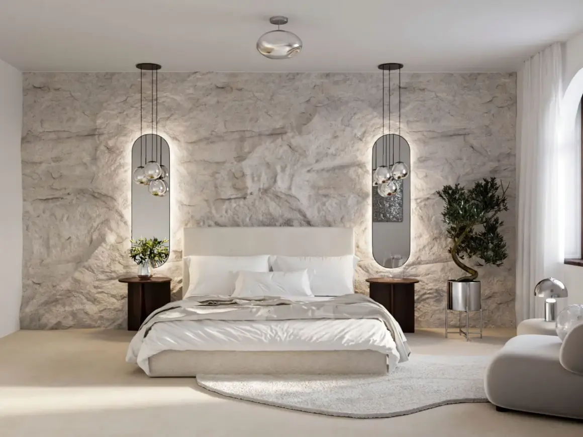 Moderne Schlafzimmer Style Ideen: Steinwand, Spiegel mit Beleuchtung, bequemes Bett und ein Olivenbaum im Topf schaffen eine luxuriöse Atmosphäre.