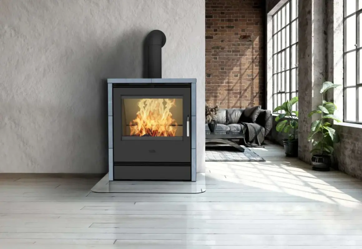 Ein moderner Kamin mit brennendem Feuer, umgeben von einer Wand aus grobem Beton und Ziegeln. Die Frage "was ist Speckstein?" wird durch die Wärme und Gemütlichkeit des Kamins beantwortet.