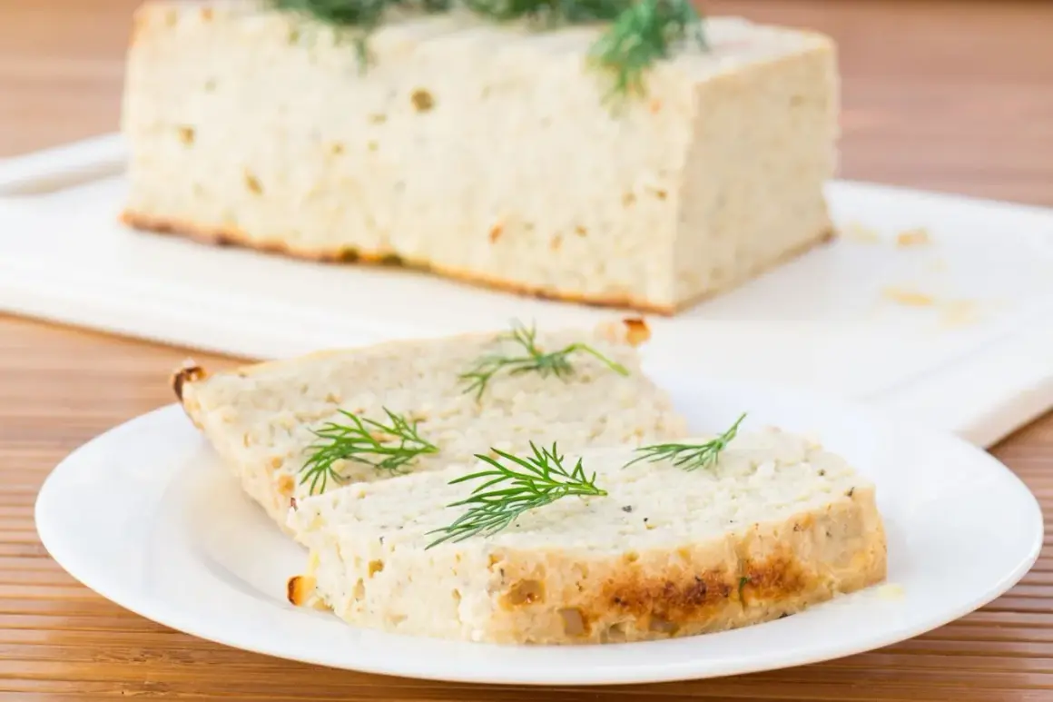 Tranche de terrine de poisson maison, garnie d'aneth frais, prête à être dégustée.