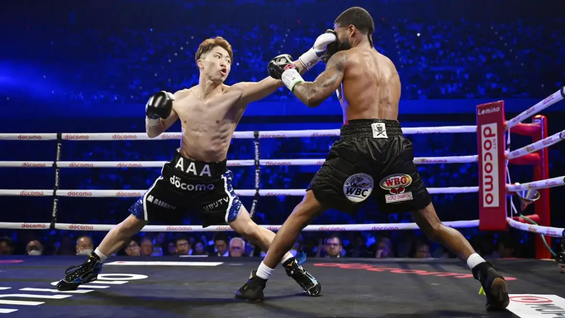 Two boxers clash in a packed arena. The frequency of how often boxers fight varies greatly depending on their level and schedule.