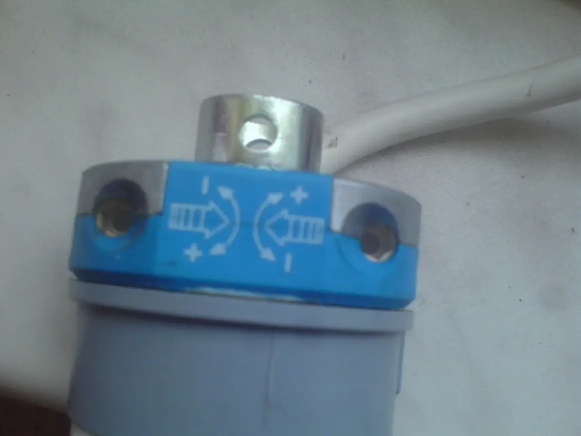 Element do regulacji krańcówek rolet z oznaczeniami kierunku i +/-.