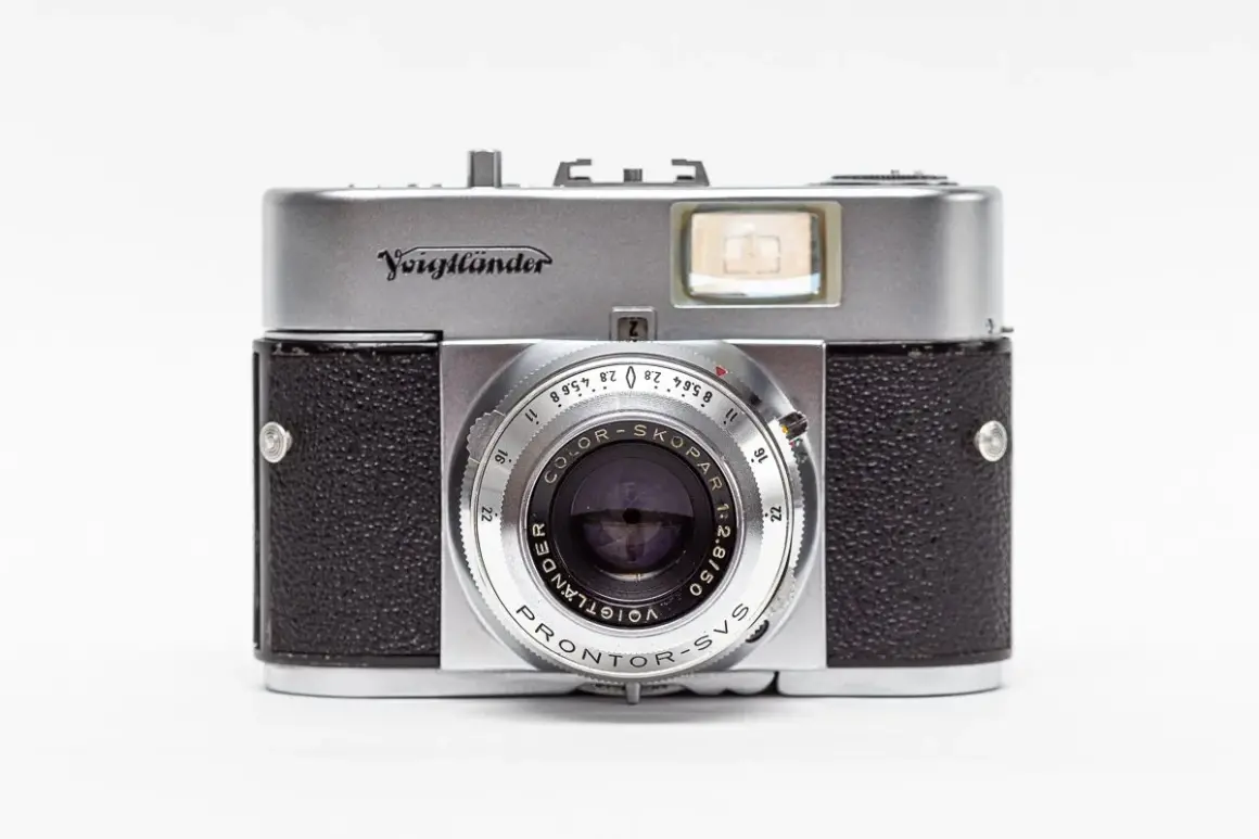 A vintage silver and black Voigtländer camera with a prominent lens and viewfinder.