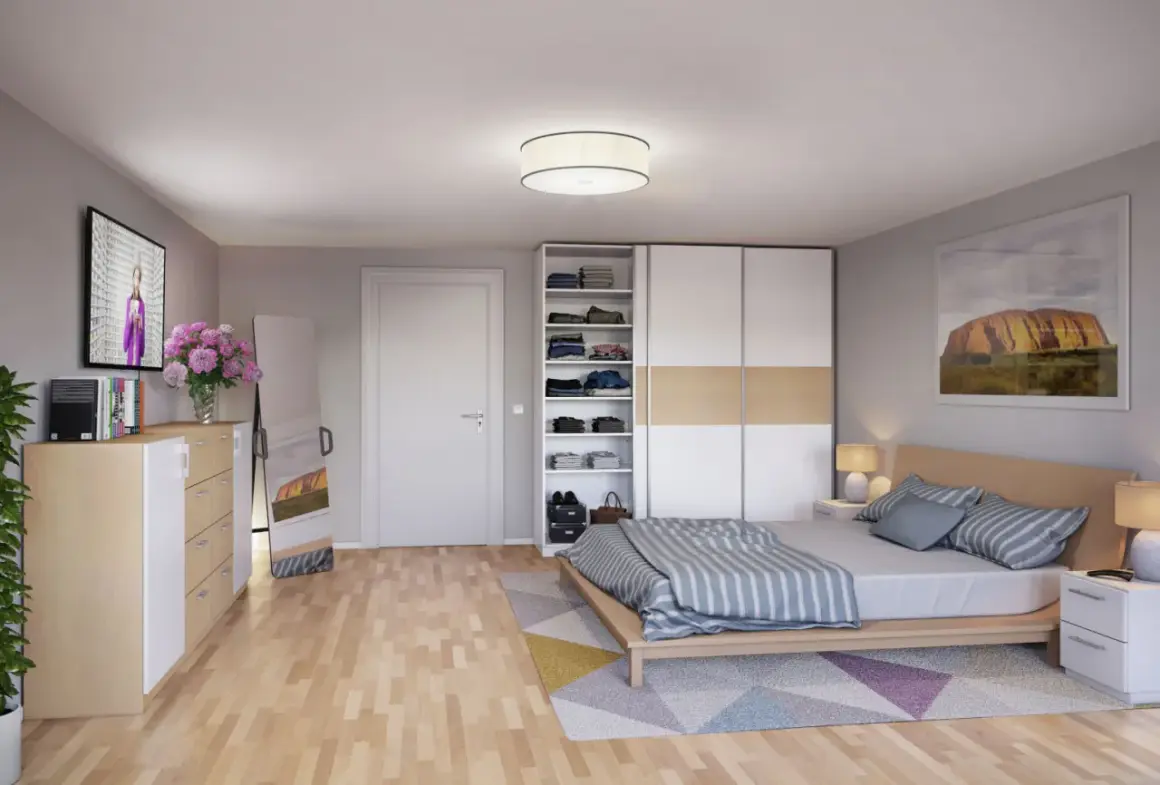 Ein gemütliches wohn- und schlafzimmer in einem kleinen raum mit Bett, Kleiderschrank, Kommode, Spiegel und TV.