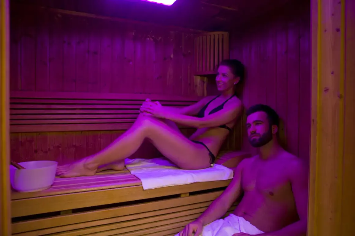 Para relaksu w saunie, jak często można chodzić na saunę? Para cieszy się ciepłem i relaksem w saunie.