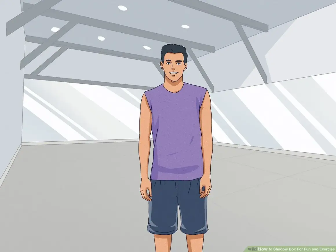 A man in athletic wear stands ready for shadow boxing in an empty gym.