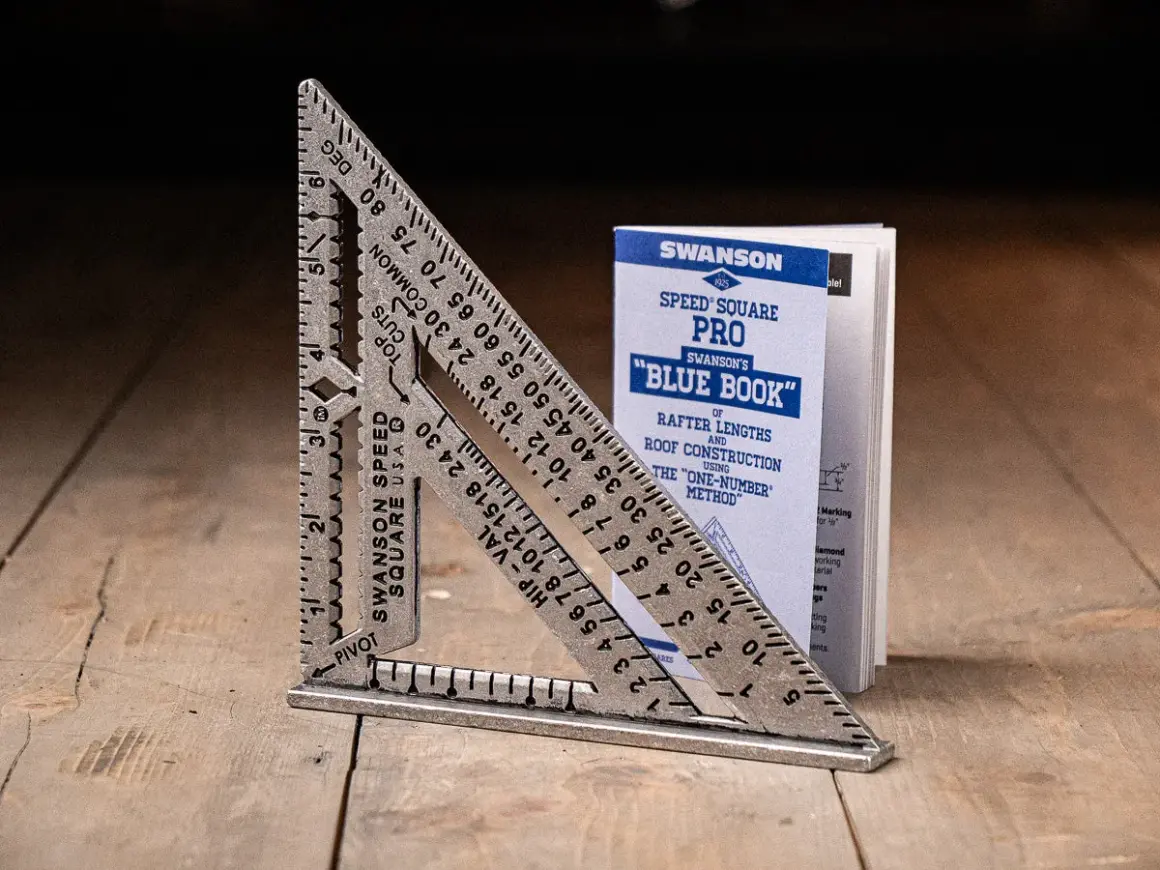 A Swanson Speed Square and its "Blue Book" guide, showing how to use a speed square for roof construction.