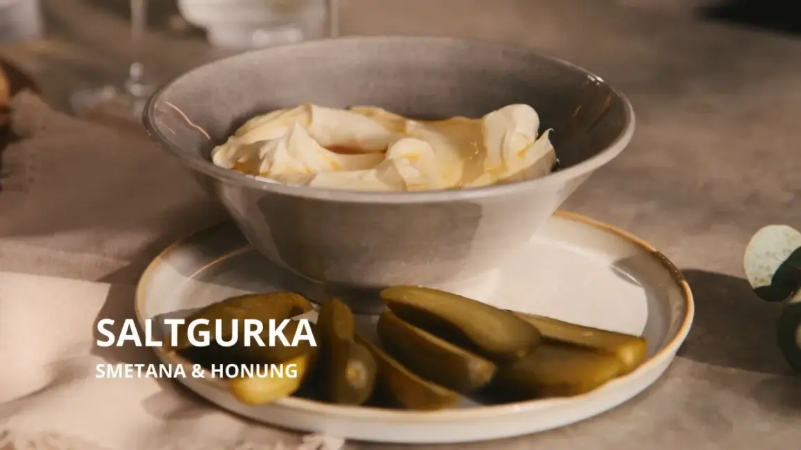 En skål med krämig smetana och honung, serverad med saltgurka. En oväntad men utsökt kombination.