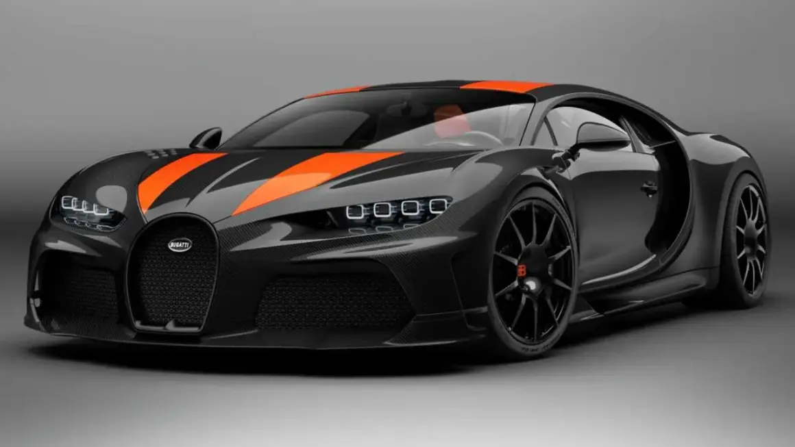 Bugatti Chiron noir et orange, prête à atteindre sa vitesse max. Un chef-d'œuvre de carbone et de puissance.