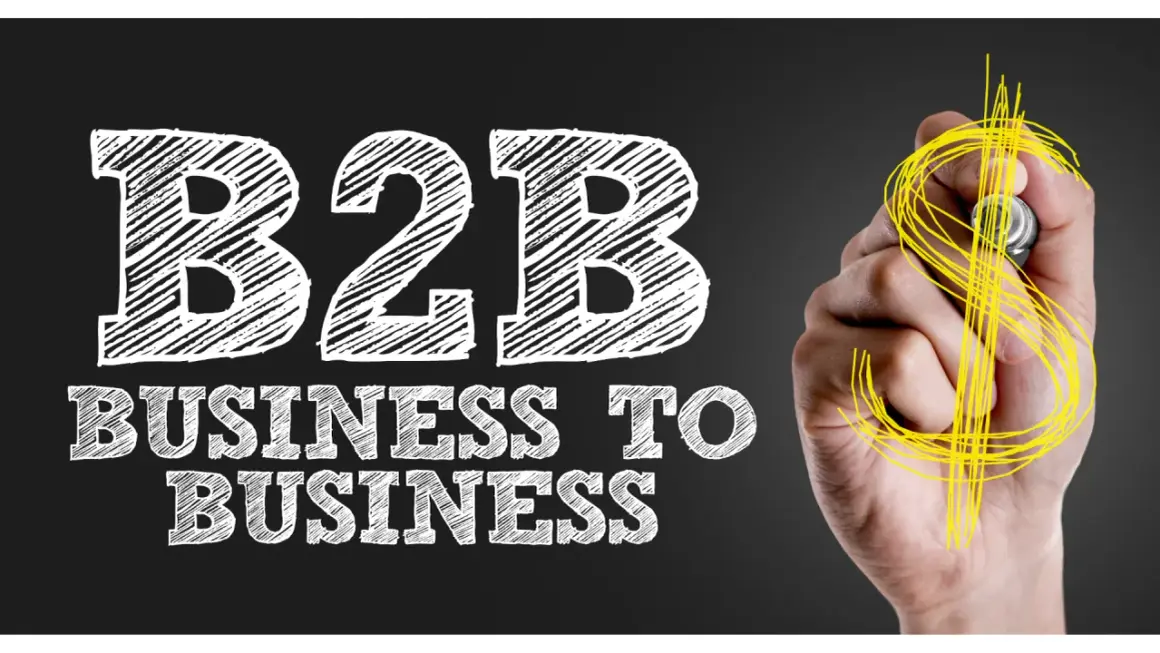 Mano disegna simbolo dollaro su lavagna con scritta "B2B Business to Business", il significato di B2B nel mondo degli affari.