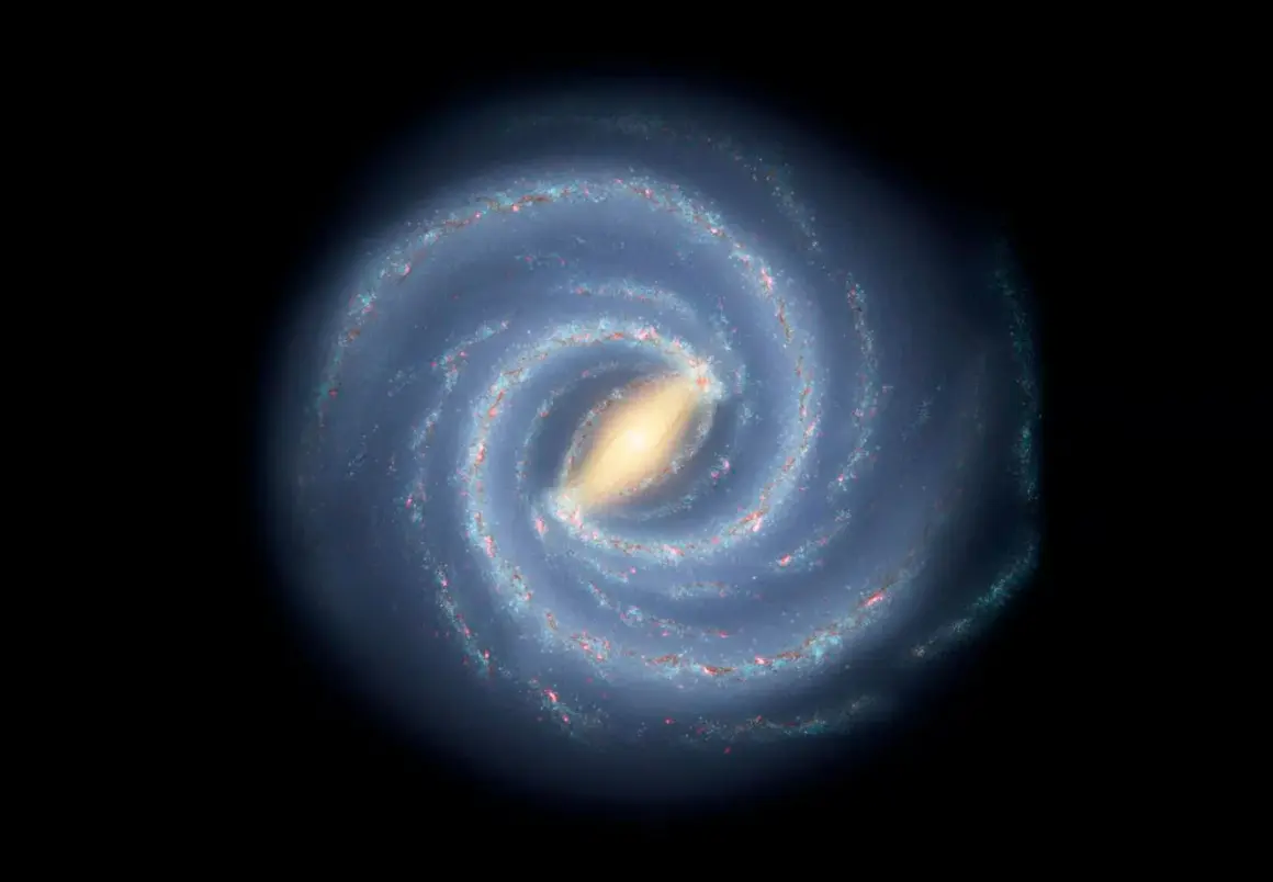 En bild av spiralformade galaxer med en ljusgul kärna och blåa armar fyllda med stjärnor och gas.
