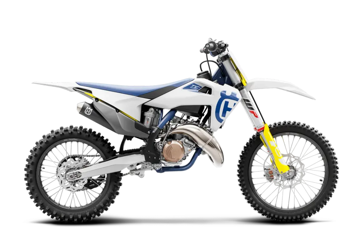 Motocykl Husqvarna TC 125 w białej i niebieskiej kolorystyce, widok z boku.