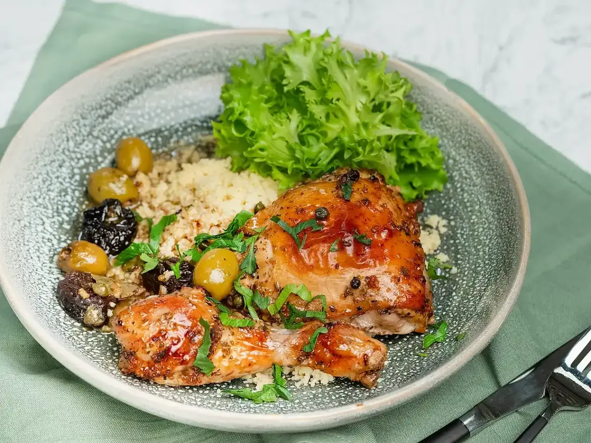 En härlig tallrik med kyckling, couscous, oliver och sallad. Ett perfekt medelhavskost recept kyckling för en smakrik måltid.
