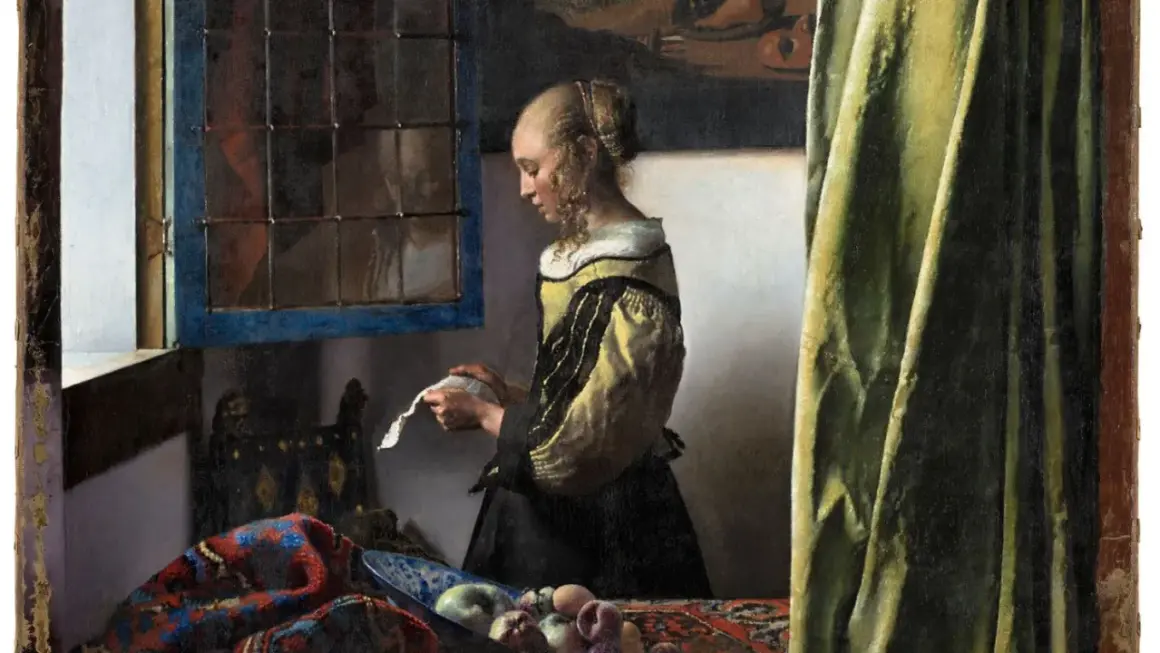 A woman in a yellow and black dress reads a letter by a window, a scene from one of Vermeer's famous paintings of women.