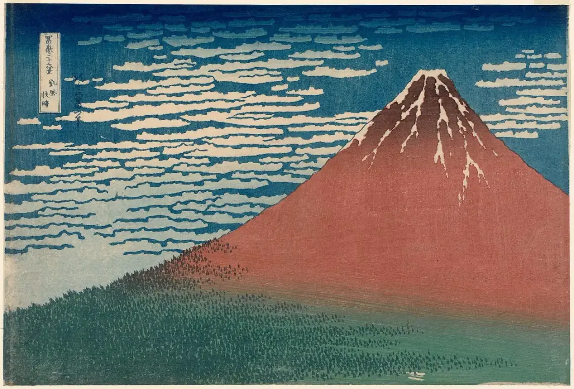 A Katsushika Hokusai artwork depicting Mount Fuji in red, with a forest at its base and a sky filled with swirling clouds.