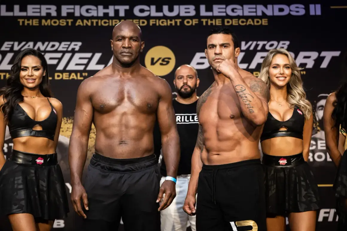 Evander Holyfield och Vitor Belfort står redo för en episk match. Ringflickor flankerar de muskulösa boxarna.