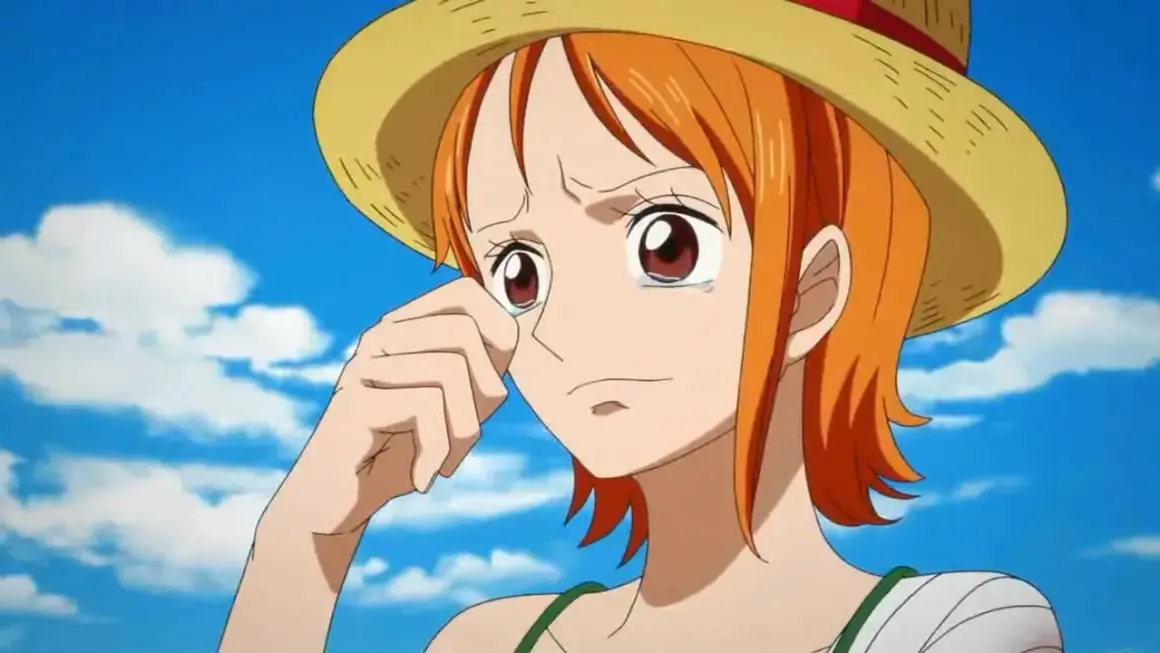 Nami One Piece weint unter ihrem Strohhut, die Hand am Auge. Ihr Arm ist bandagiert.