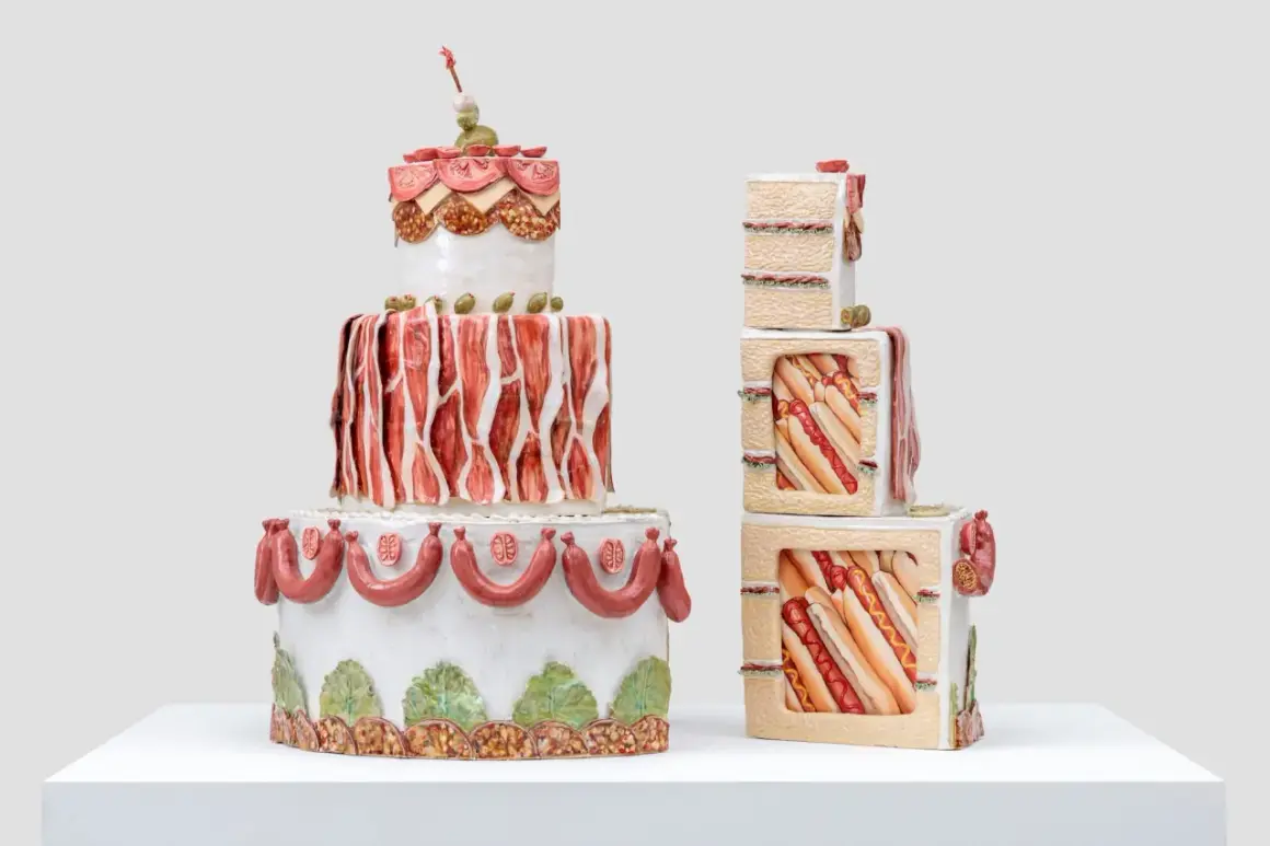 Whimsical Wayne Thiebaud cakes, one a tiered tower of savory meats and olives, the other stacked cubes revealing hot dogs and sandwiches.