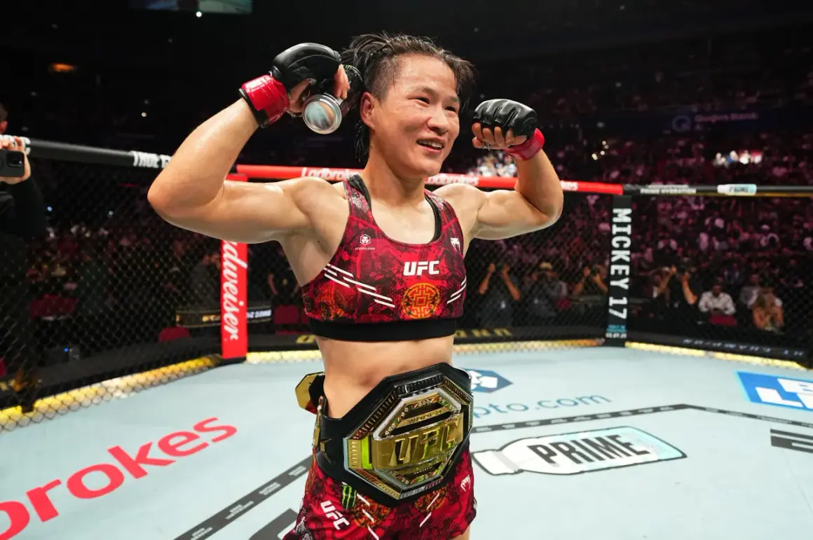 UFC strawweight champion celebrates victory, flexing her muscles and holding a drink can.