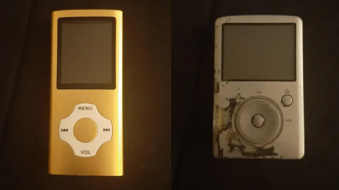 A new gold mp3 player sits next to a worn, scratched silver one.