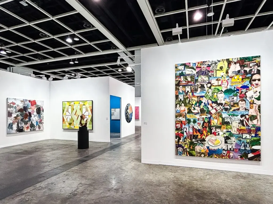 A vibrant collage artwork dominates the wall at Art Basel, showcasing a diverse collection of images.